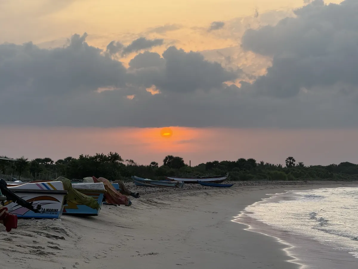 Kayankerni beach at sunset, fishing boats drawn up on the sand